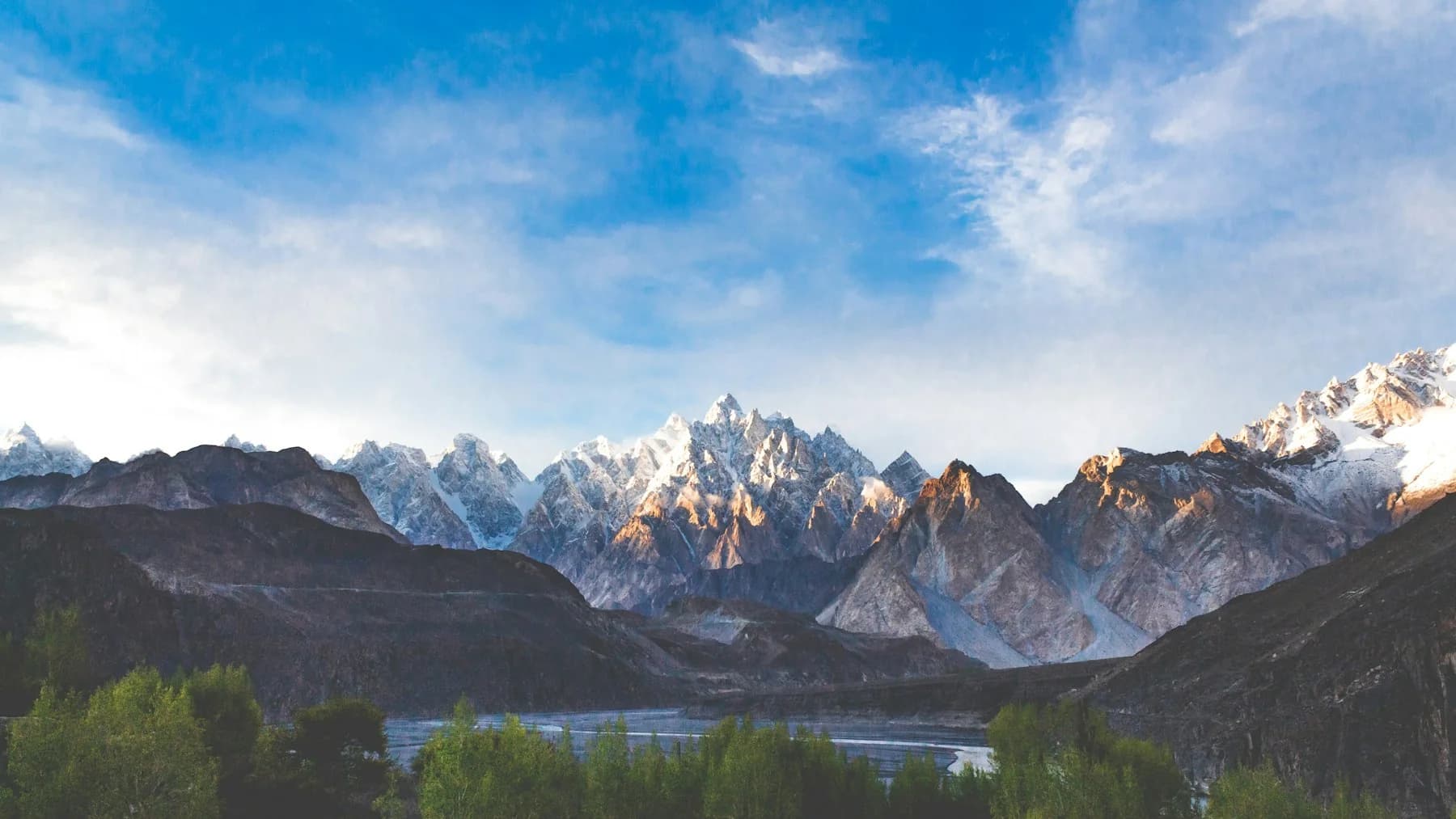 The Karakoram mountains above a glacial river in northern Pakistan.